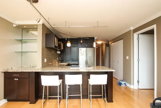 a kitchen with kitchen island granite countertop wooden cabinets and counter space