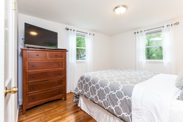18 Mountain Road Waltham, MA 02451 - Photo 11 of 22 a bedroom with a bed and a flat screen tv