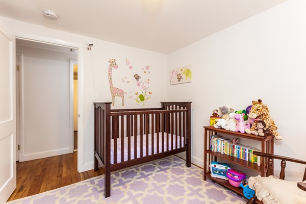 18 Mountain Road Waltham, MA 02451 - Photo 12 of 22 a bedroom with baby crib and wooden floor