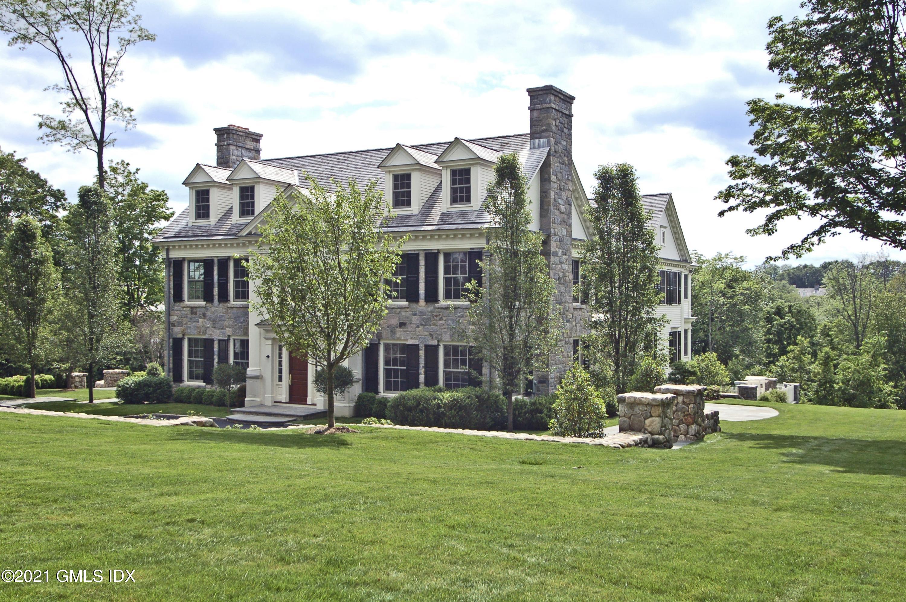 a front view of a building with a garden