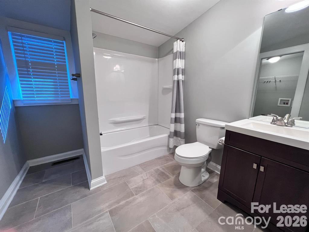 2104 Moose Road Kannapolis, NC 28083 - Photo 15 of 20 a bathroom with a granite countertop toilet a sink and a shower