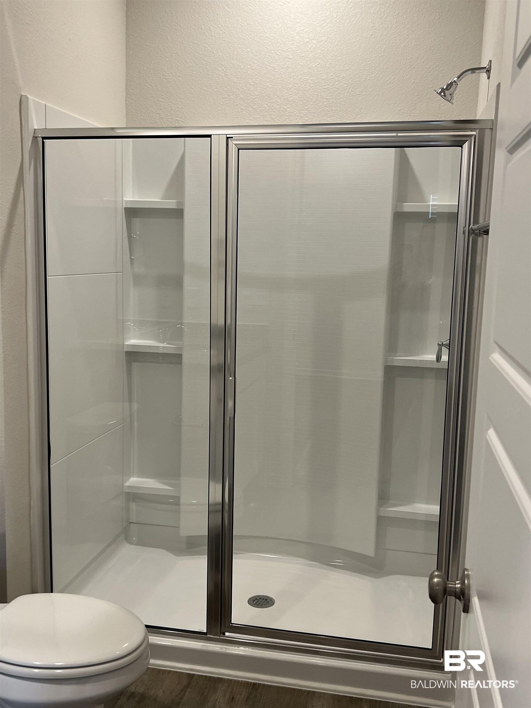 12829 Patriot Way Daphne, AL 36527 - Photo 27 of 38 Bathroom featuring toilet, hardwood / wood-style flooring, and a shower with shower door