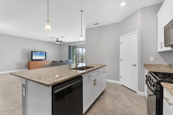 a living room with granite countertop furniture and chandelier