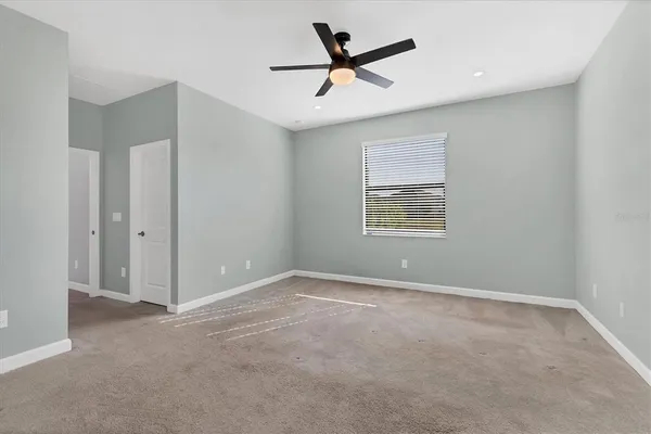 an empty room with a kitchen and a window