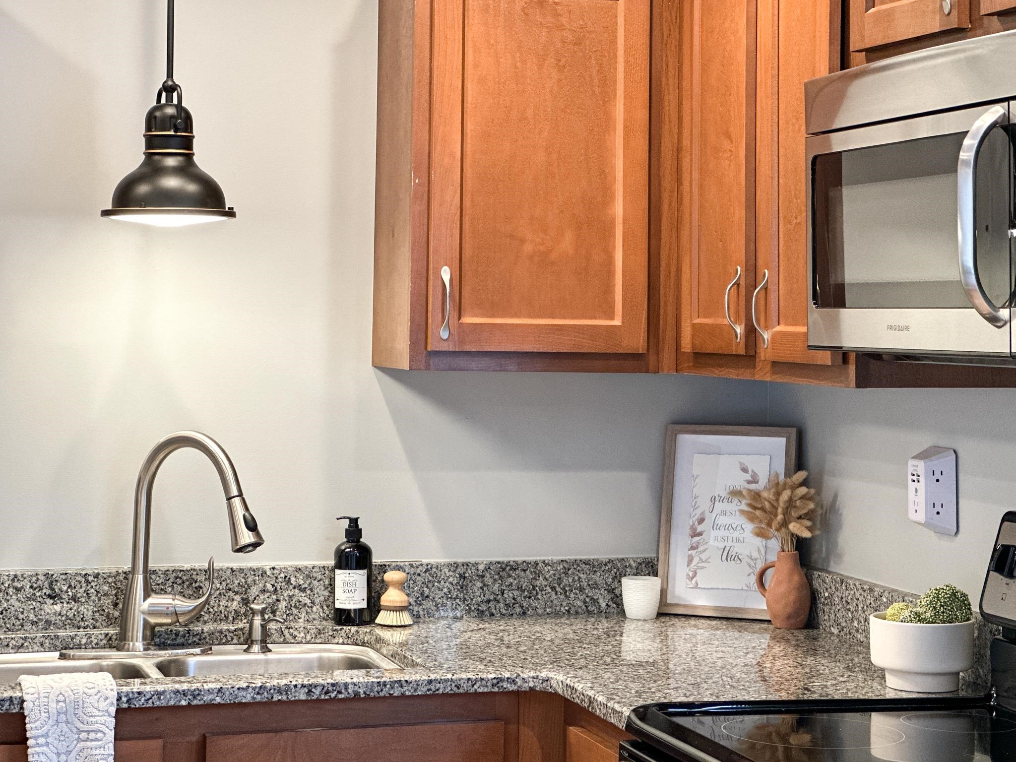 7472 Lilly Square Dayton, VA 22821 - Photo 16 of 30 a kitchen with granite countertop a stove a sink and cabinets