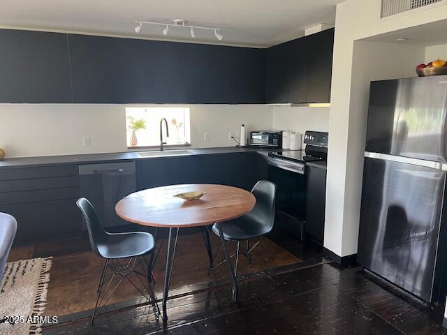 1436 South Terrace Road, Unit 102 Tempe, AZ 85281 - Photo 15 of 25 a kitchen with a table chairs and a refrigerator