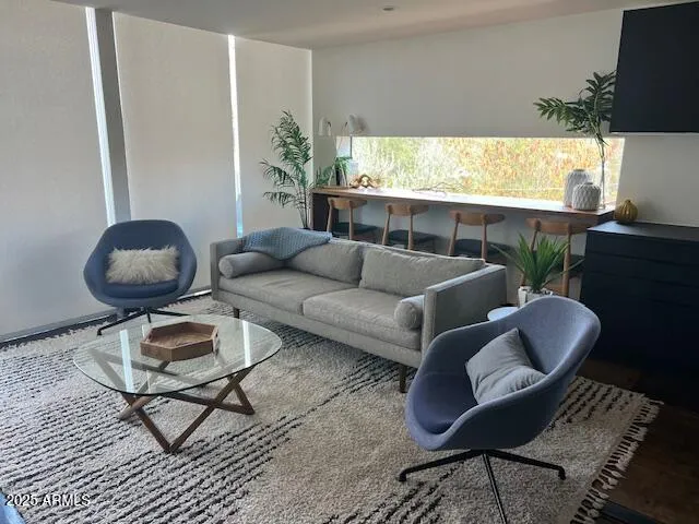 a living room with furniture and a large window