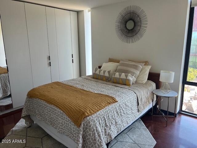 1436 South Terrace Road, Unit 102 Tempe, AZ 85281 - Photo 20 of 25 a bedroom with a bed and cabinets