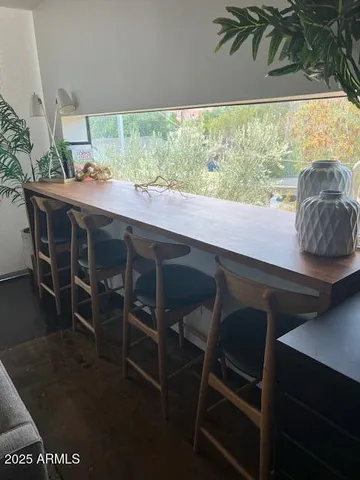 a dining room with furniture window and wooden floor