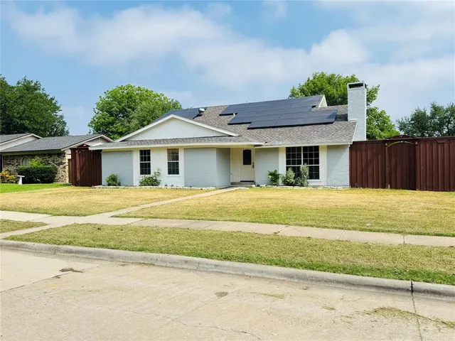 a front view of house with a garden