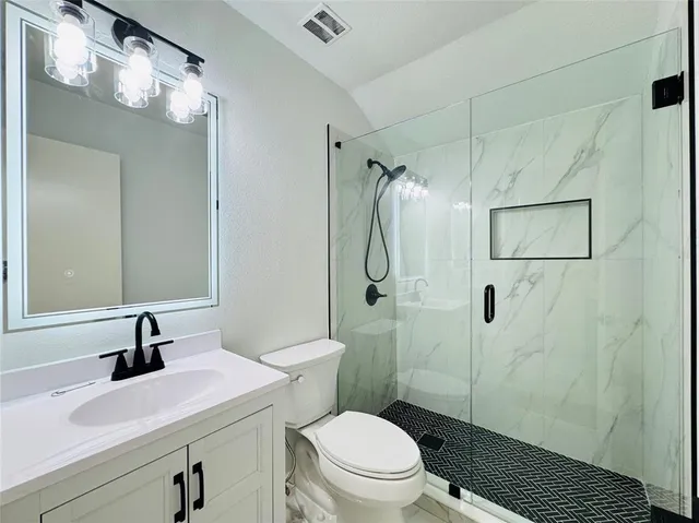 a bathroom with a toilet sink and shower