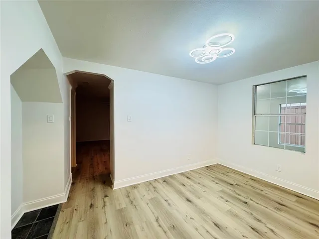 a view of kitchen with stainless steel appliances granite countertop a sink and cabinets