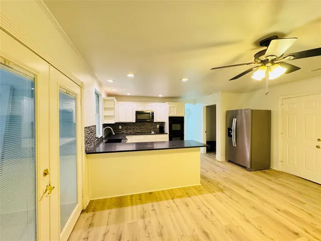 a large kitchen with stainless steel appliances granite countertop a stove and a sink