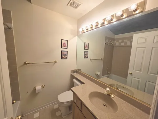 a bathroom with a sink toilet and mirror