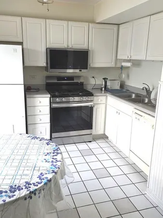 a kitchen with a stove a refrigerator and a sink