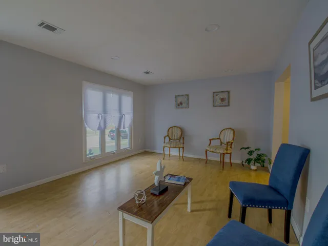 a living room with fireplace furniture and a window