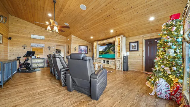 a room with stainless steel appliances kitchen island granite countertop furniture and a fireplace