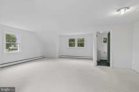 an empty room with windows and closet