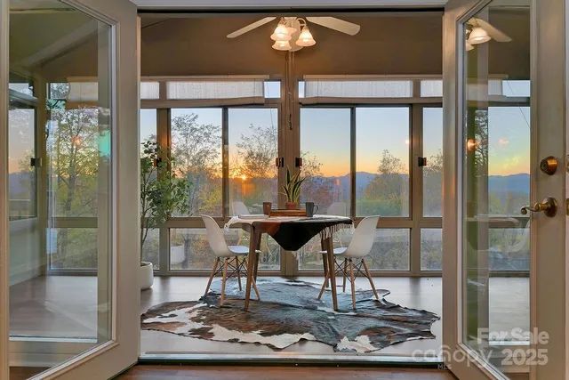 a living room with a floor to ceiling window and a table