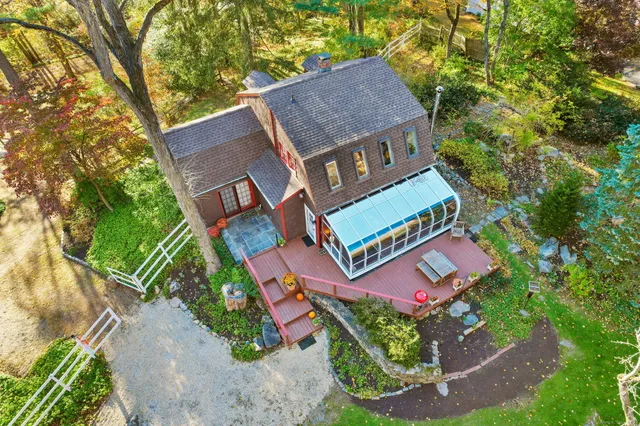an aerial view of a house with garden space and street view