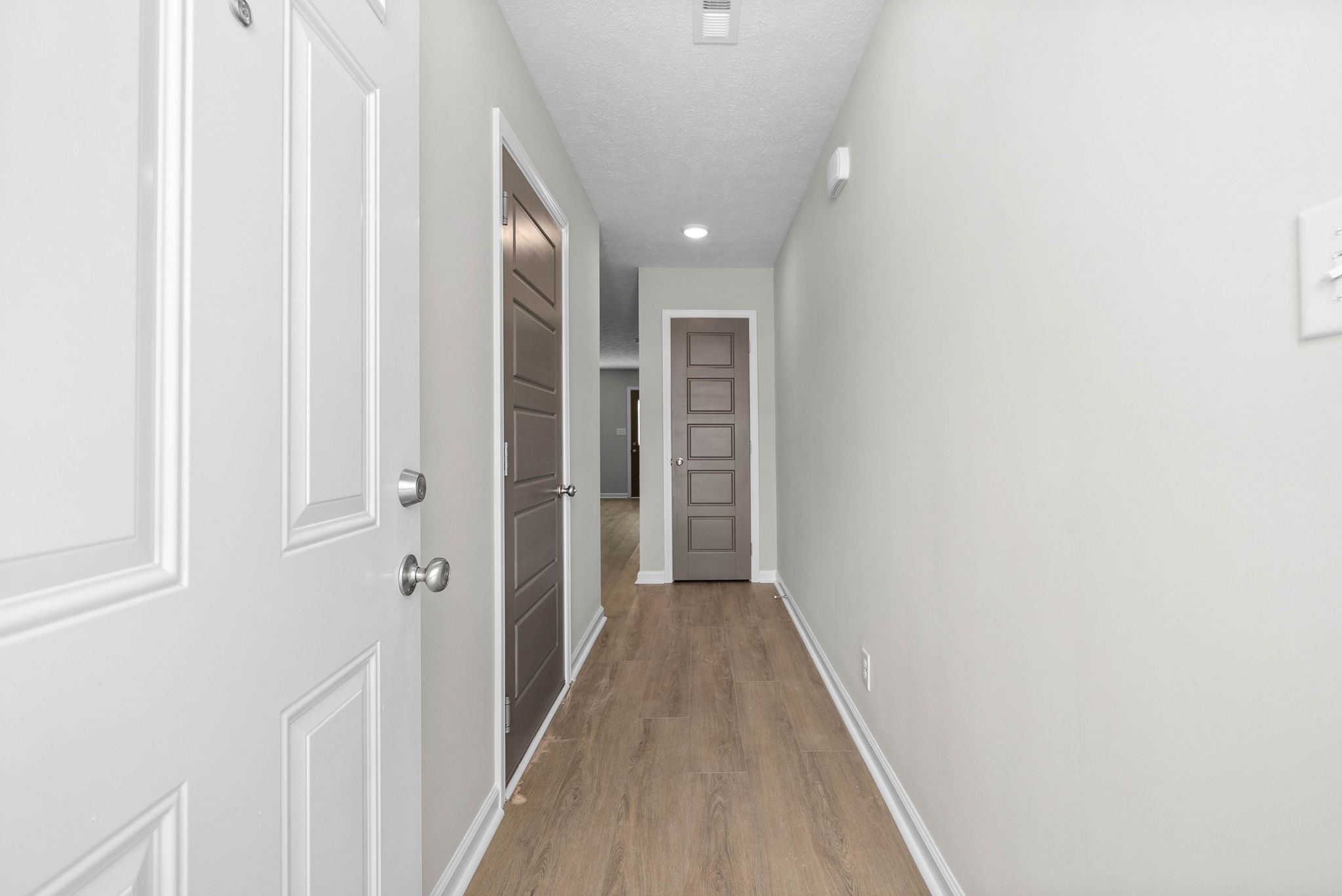 301 Longshadow Trail, Unit D Clarksville, TN 37043 - Photo 4 of 29 a view of a hallway with wooden floor and a bathroom