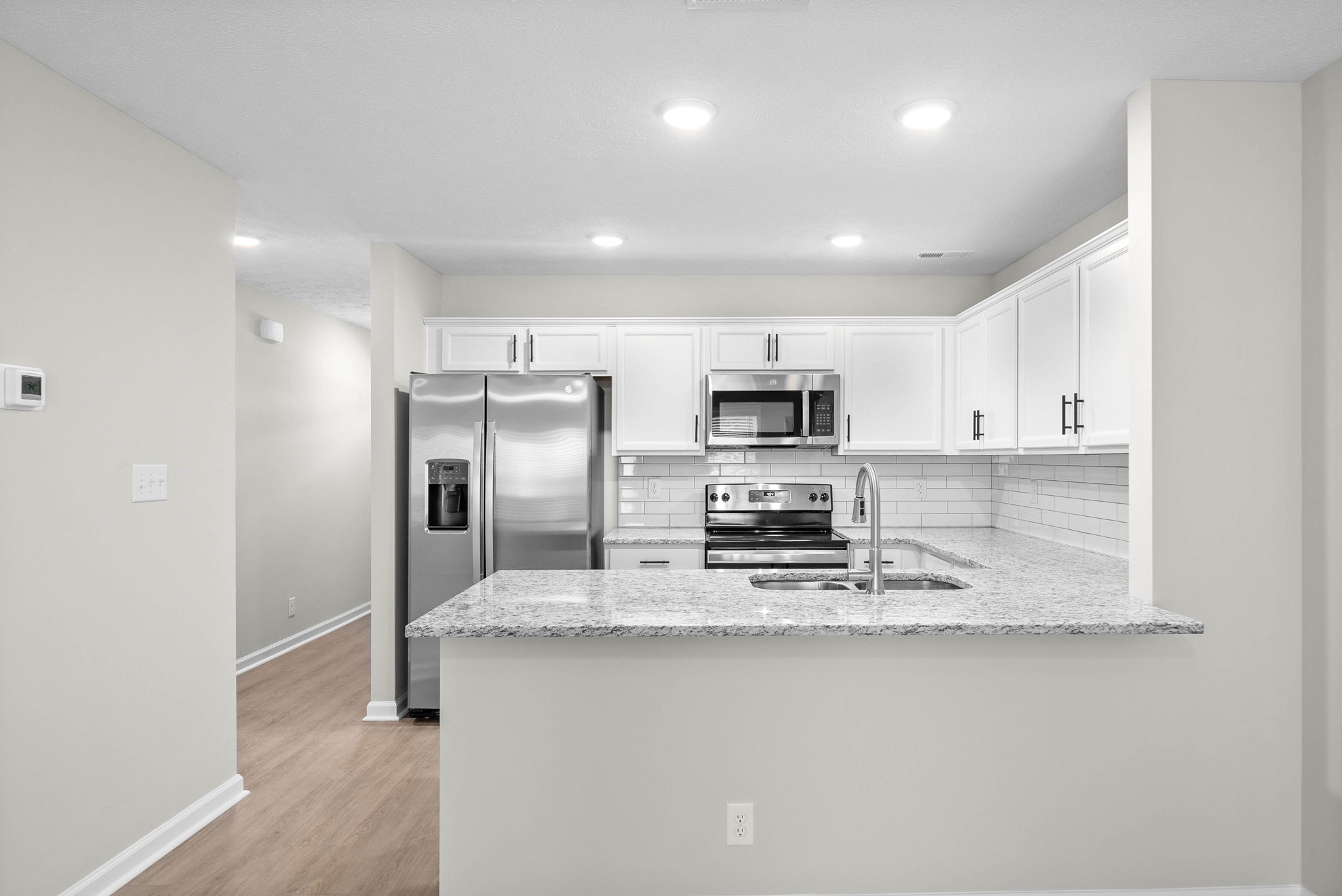 301 Longshadow Trail, Unit D Clarksville, TN 37043 - Photo 6 of 29 a kitchen with stainless steel appliances a sink and a refrigerator