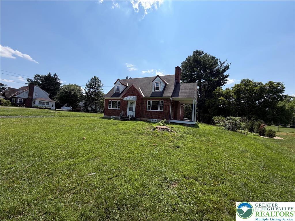 848 Hausman Road Allentown, PA 18104 - Photo 3 of 11 A charming brick residence awaits on a generous, verdant lawn.