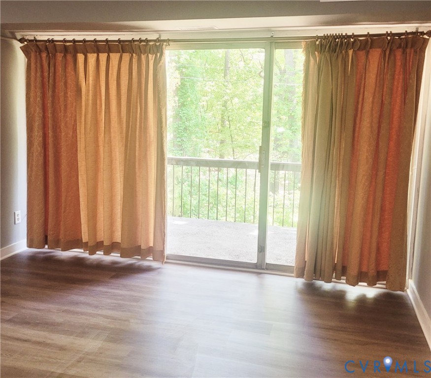 5204 Castlewood Road, Unit C Richmond, VA 23234 - Photo 3 of 12 a view of a door with wooden floor and a window