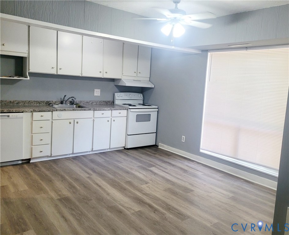 5204 Castlewood Road, Unit C Richmond, VA 23234 - Photo 5 of 12 a kitchen with granite countertop white cabinets and white appliances
