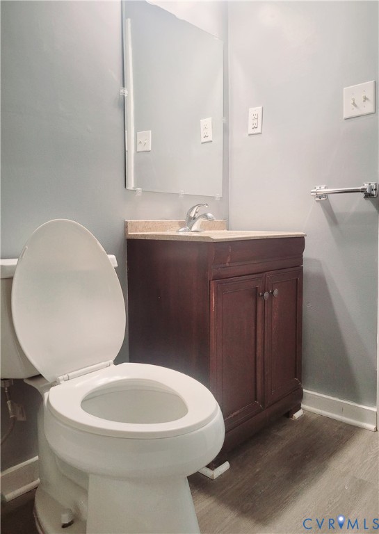 5204 Castlewood Road, Unit C Richmond, VA 23234 - Photo 6 of 12 a bathroom with a toilet a sink and mirror