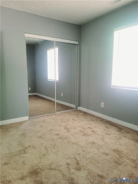5204 Castlewood Road, Unit C Richmond, VA 23234 - Photo 8 of 12 a view of an empty room with window and closet area