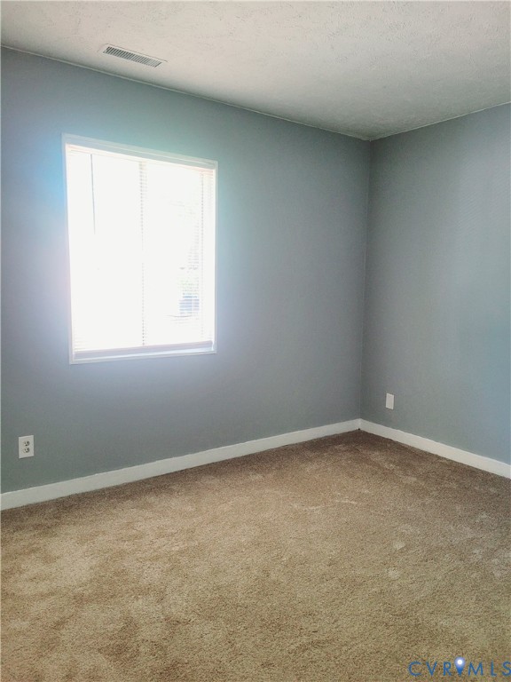 5204 Castlewood Road, Unit C Richmond, VA 23234 - Photo 9 of 12 an empty room with a window