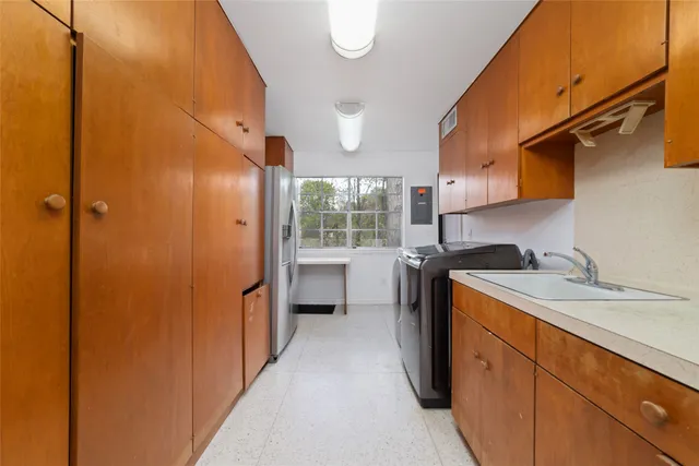 a kitchen with a sink and a refrigerator