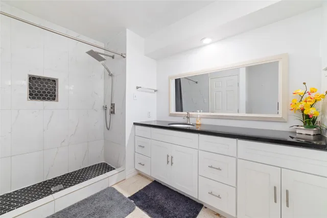 a bathroom with a double vanity sink and a mirror