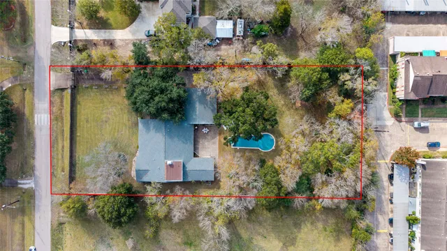 an aerial view of residential house with outdoor space and swimming pool