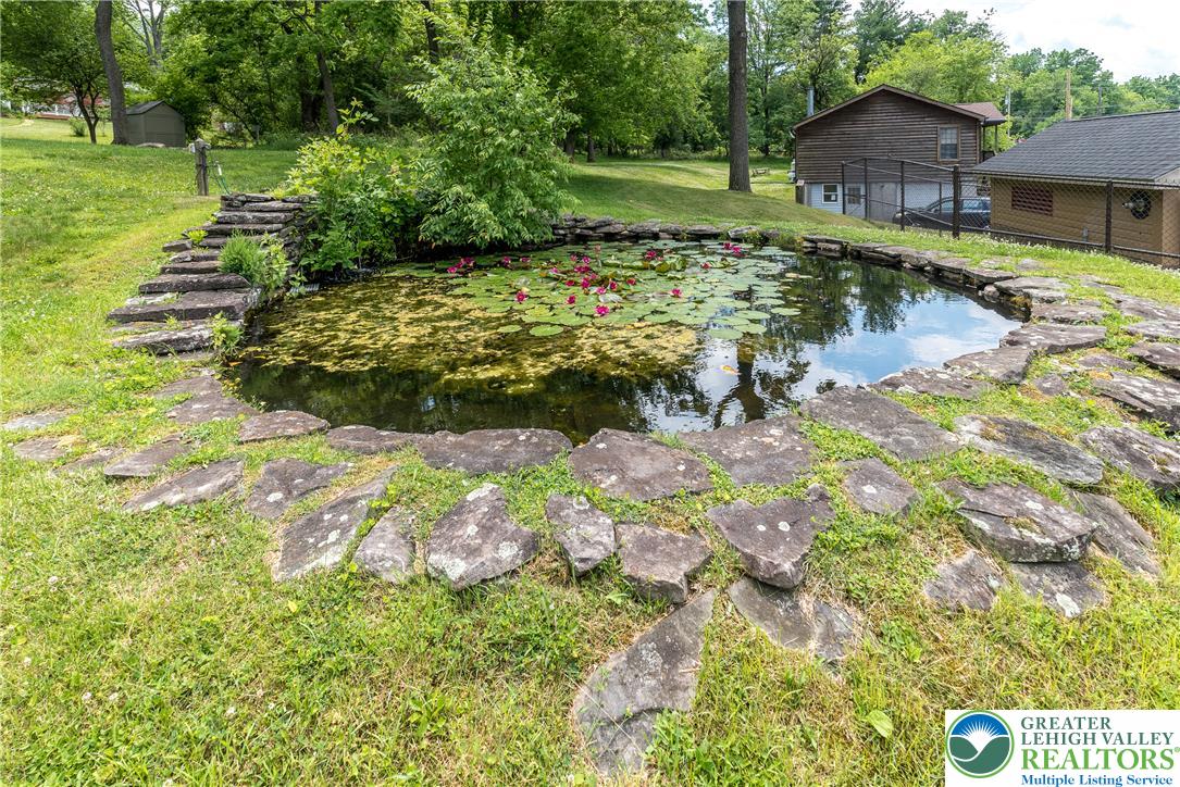1815 Leithsville Road Hellertown, PA 18055 - Photo 36 of 38 A tranquil pond adorned with water lilies creates a serene outdoor retreat.