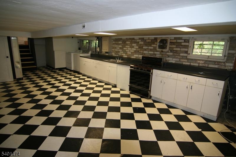220 South Ridgewood Road South Orange, NJ 07079 - Photo 13 of 14 a kitchen with a checkered floor and white cabinets