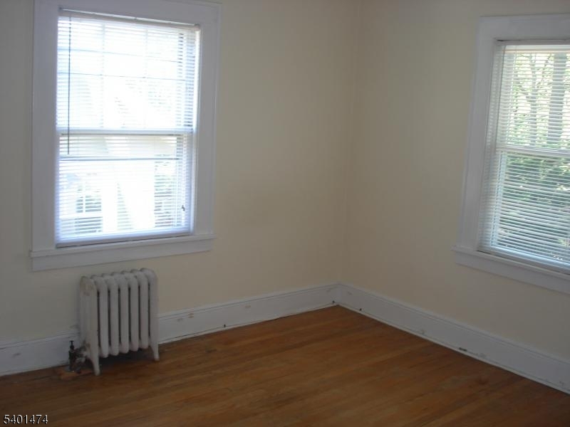 220 South Ridgewood Road South Orange, NJ 07079 - Photo 8 of 14 an empty room with wooden floor and windows