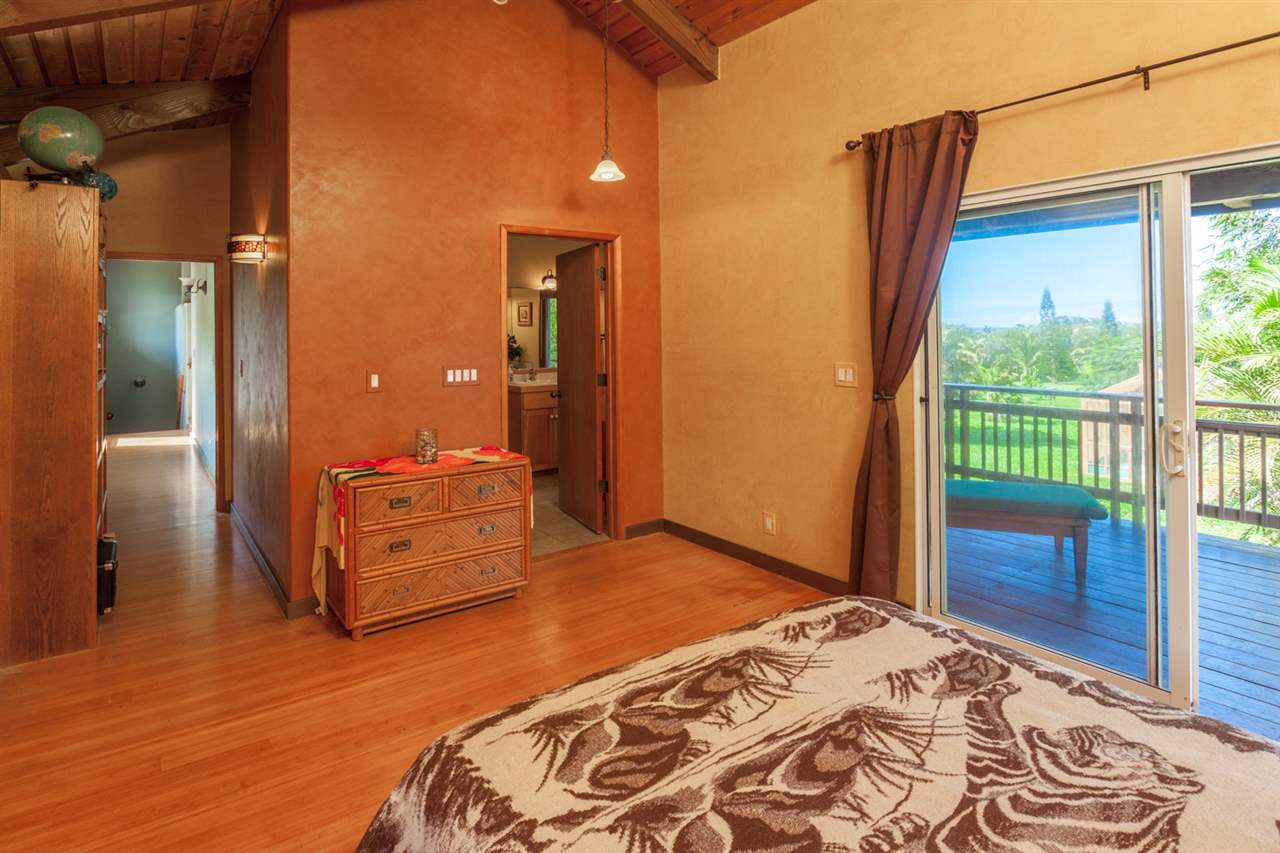 480 Hoolawa Road Haiku, HI 96708 - Photo 24 of 30 a bedroom with a bed and a dresser next to a window