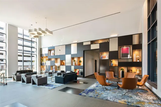 a living room with furniture a chandelier and a large window