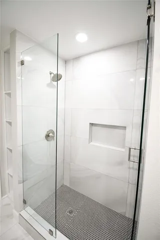 a bathroom with a glass shower door