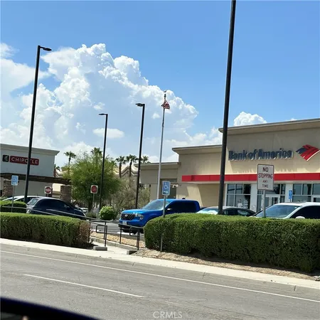 a large parking space with lots of trees in the background