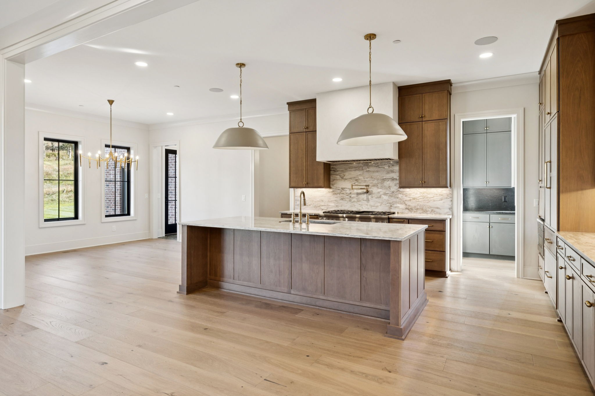 9204 Horton Highway College Grove, TN 37046 - Photo 14 of 87 a large kitchen with stainless steel appliances kitchen island granite countertop a stove a sink a refrigerator and a wooden floor