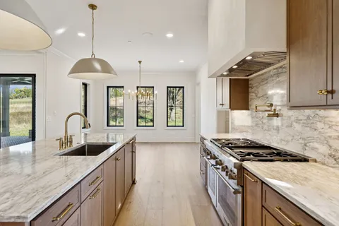 a view of a hallway with wooden floor and entryway