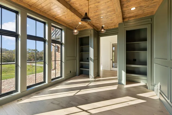 a view of an empty room with wooden floor