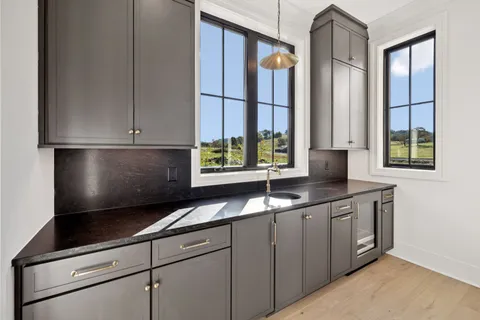 a bathroom with a sink shower and a mirror