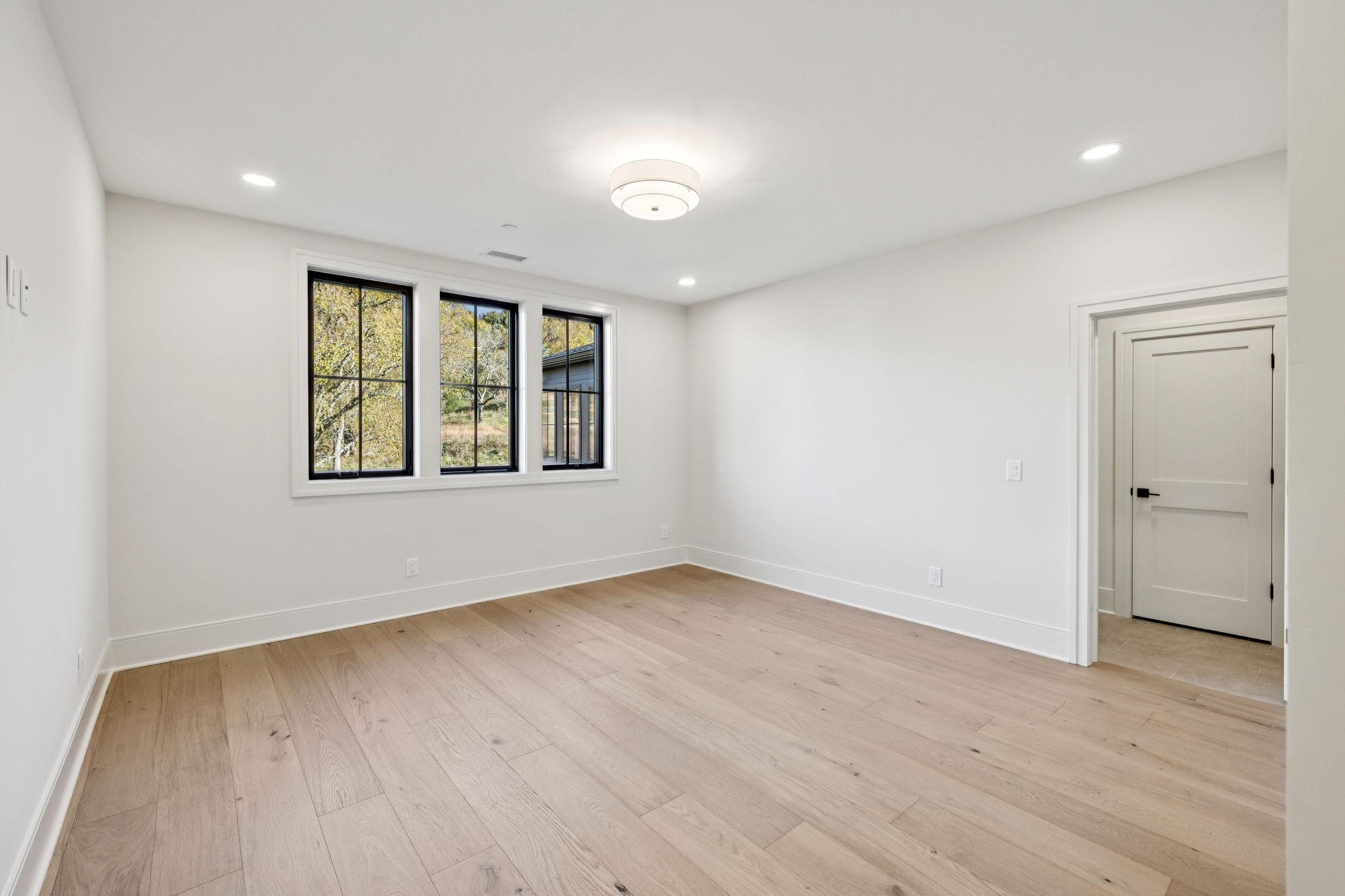 9204 Horton Highway College Grove, TN 37046 - Photo 46 of 87 an empty room with wooden floor and windows