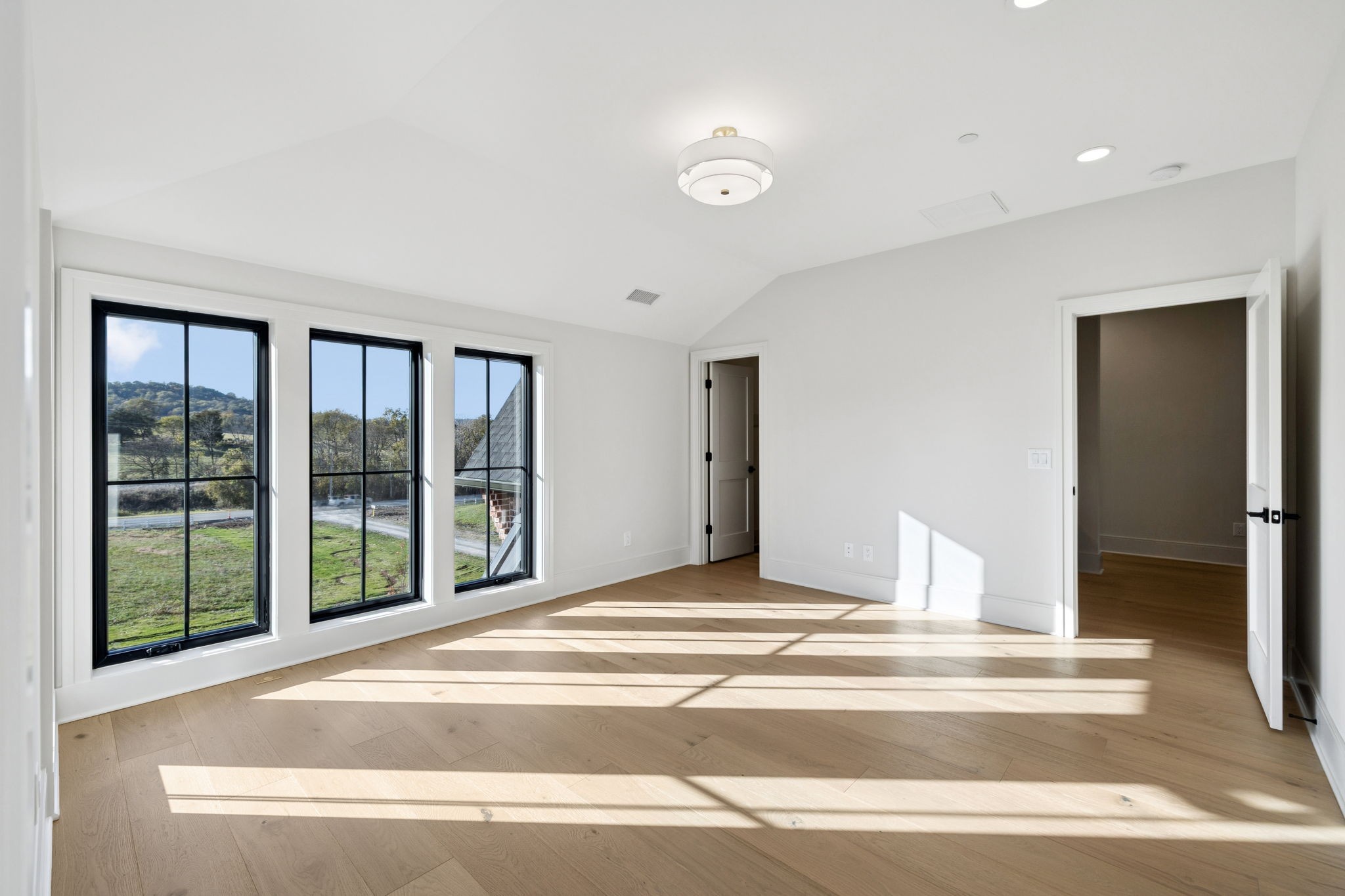 9204 Horton Highway College Grove, TN 37046 - Photo 50 of 87 a view of white house with a floor to ceiling window and a flat screen tv