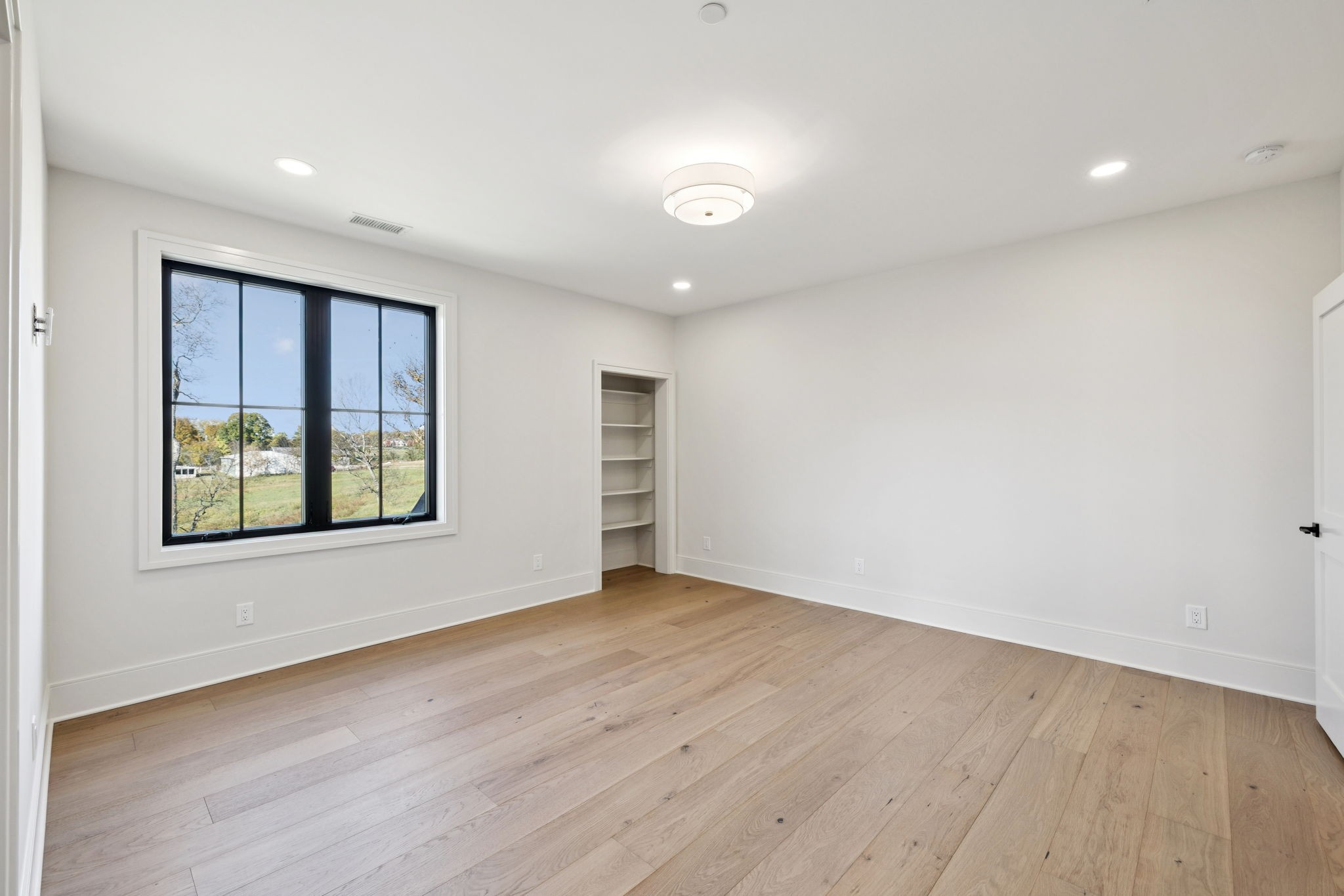 9204 Horton Highway College Grove, TN 37046 - Photo 55 of 87 an empty room with wooden floor and windows