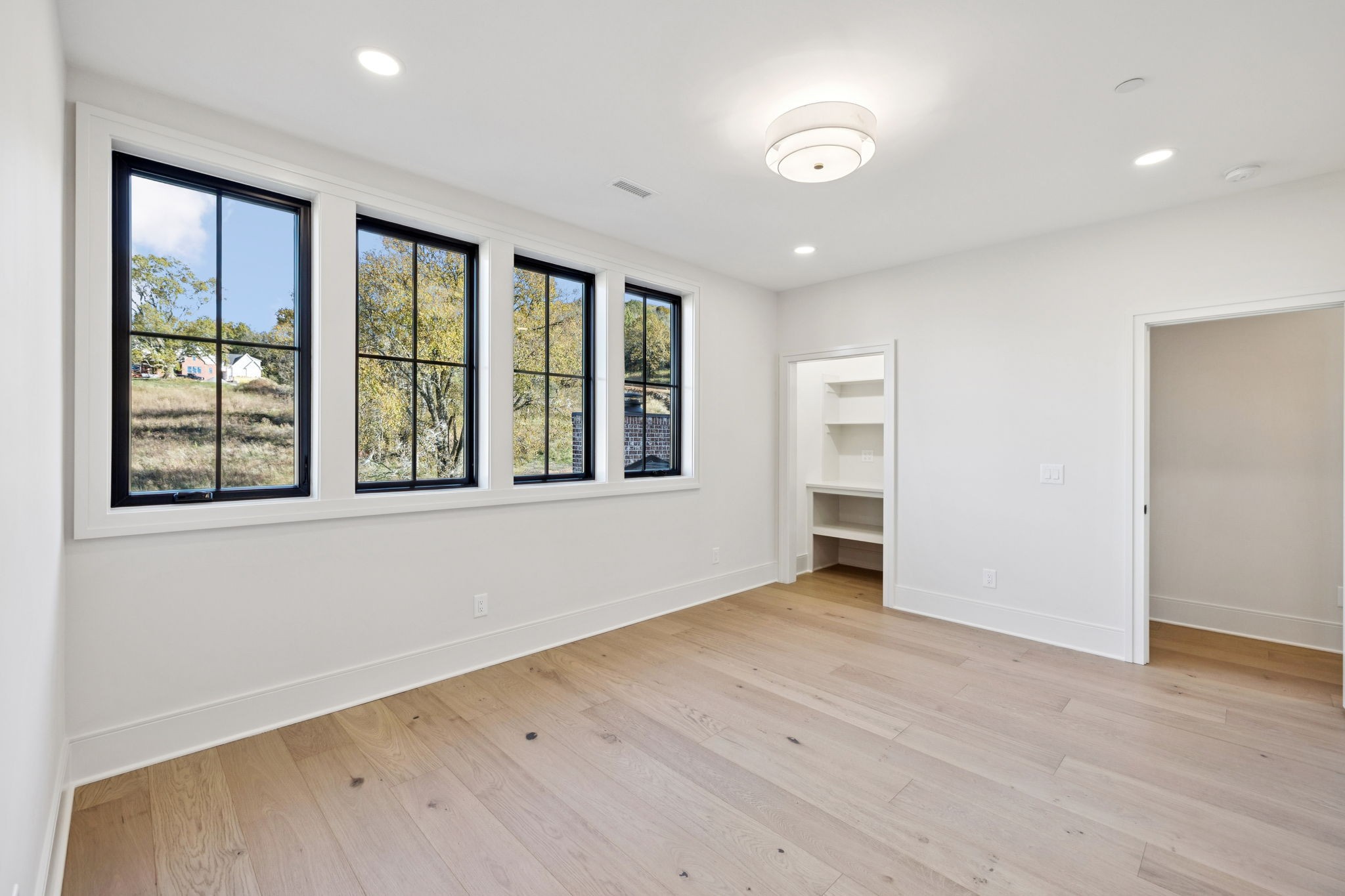 9204 Horton Highway College Grove, TN 37046 - Photo 60 of 87 an empty room with wooden floor and windows